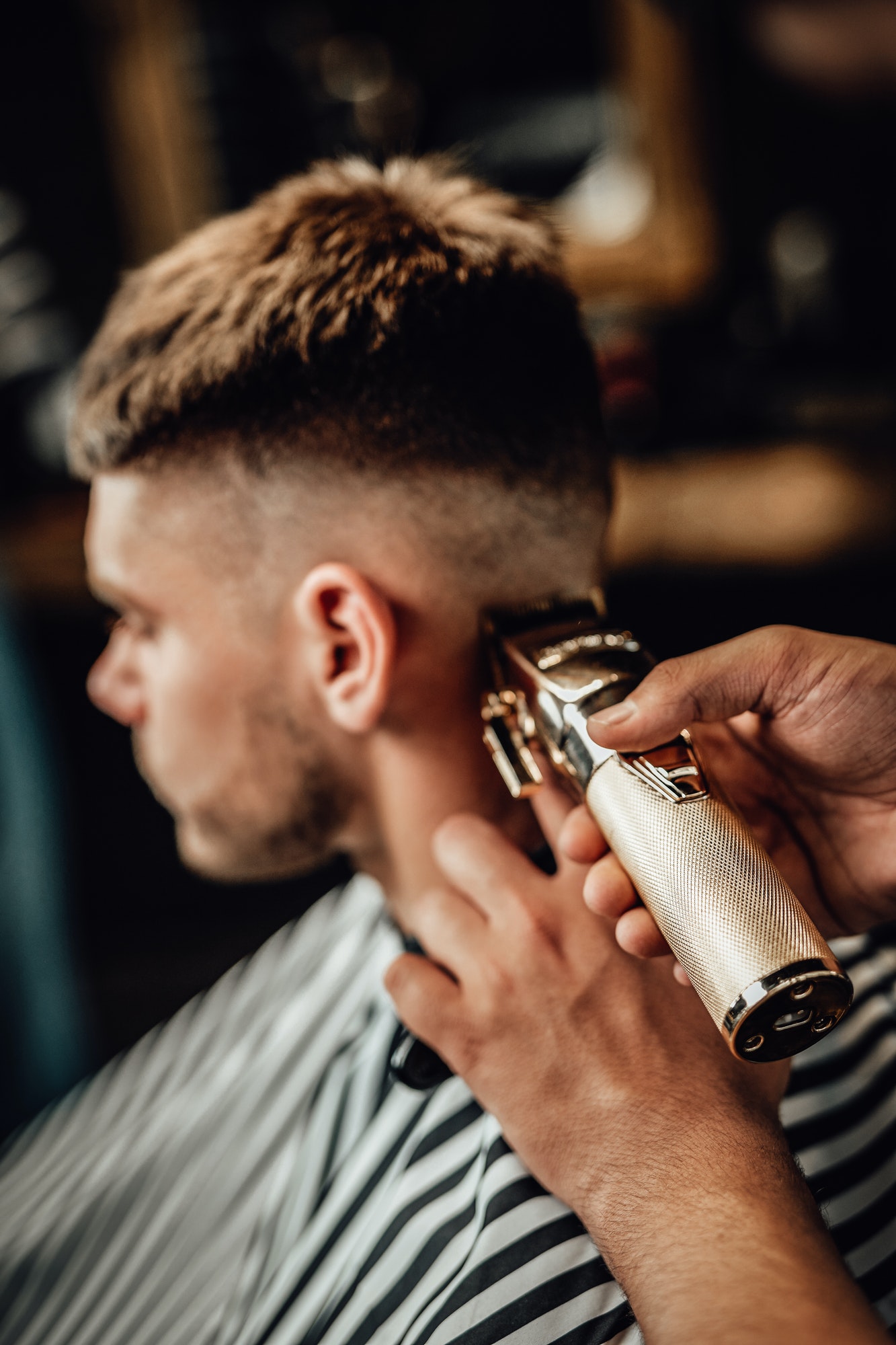 barber-cutting-guy-s-hars-with-silver-clipper-in-saloon.jpg